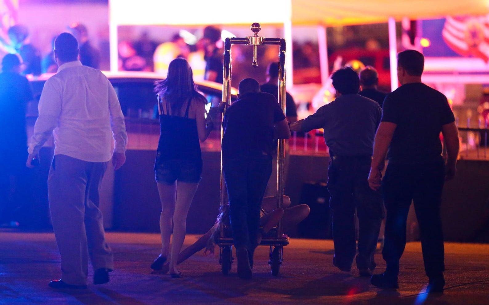 En skadad kvinna körs på en vagn efter masskjutningen i Las Vegas. FOTO: AP
