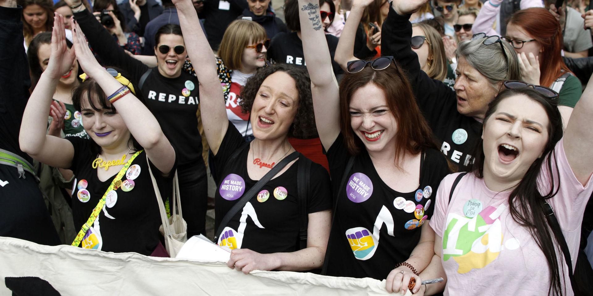 People from the &quot;Yes&quot; campaign react as the results of the votes begin to come in, after the Irish referendum on the 8th Amendment of the Irish Constitution at Dublin Castle, in Dublin, Ireland, Saturday May 26, 2018. The first official results for Ireland&apos;s landmark abortion referendum have begun to come in, indicating a landslide win for abortion rights campaigners is likely in diverse constituencies across the country. (AP Photo/Peter Morrison)