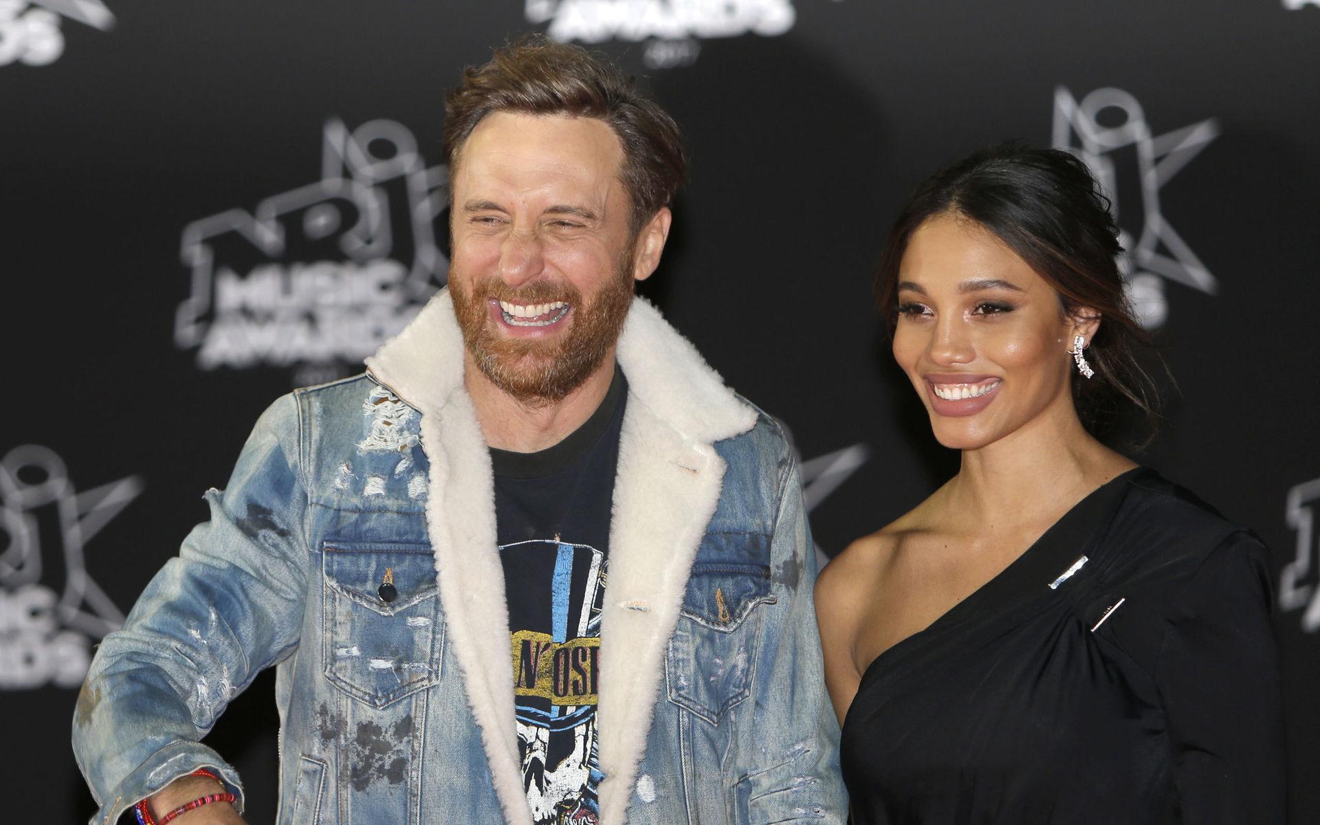 French DJ and producer of electro music, David Guetta, left, arrives with his partner Jessica Ledon at the Cannes festival palace, to take part in the NRJ Music awards ceremony, Saturday, Nov. 4, 2017, in Cannes, southeastern France. (AP Photo/Claude Paris)