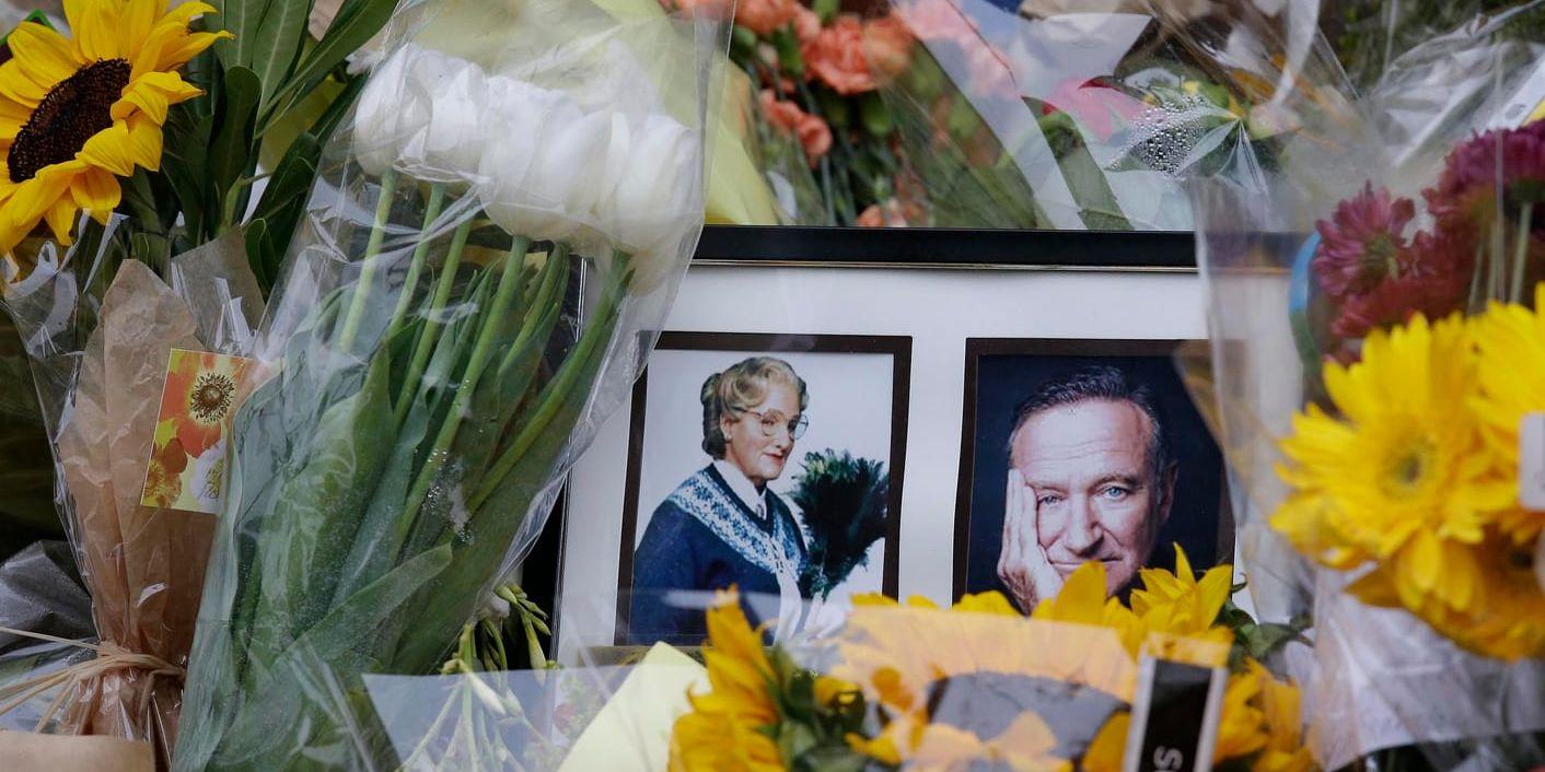 Blommor och bilder på en minnesplats efter Robin Williams död. Arkivbild.