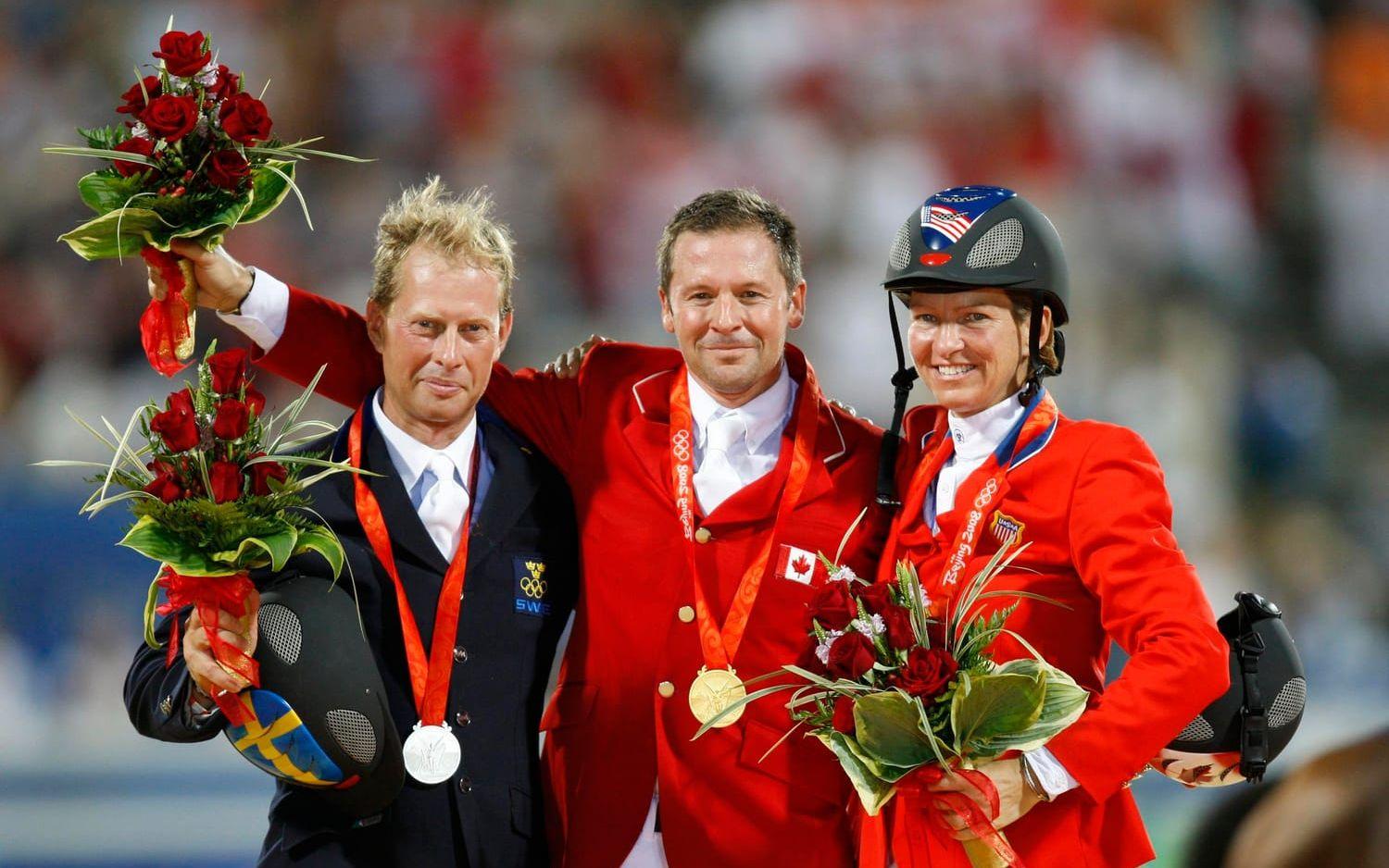 Eric Lamaze i mitten med OS-guld från Peking-OS 2008. Tävlar för Kanada i ridsport. Fälld 1996 och 2000.