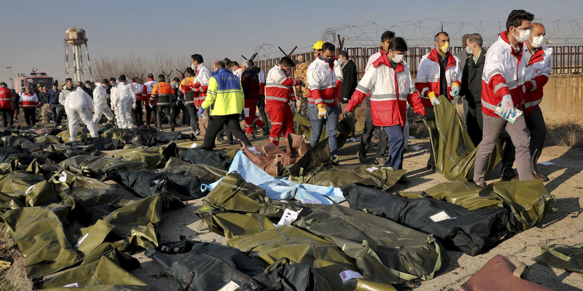 Rescue workers recover bidiesof victims at the scene where a Ukrainian plane crashed in Shahedshahr, southwest of the capital Tehran, Iran, Wednesday, Jan. 8, 2020. A Ukrainian airplane with more than 170 people crashed on Wednesday shortly after takeoff from Tehran&apos;s main airport, killing all onboard. (AP Photo/Ebrahim Noroozi)  ENO122
