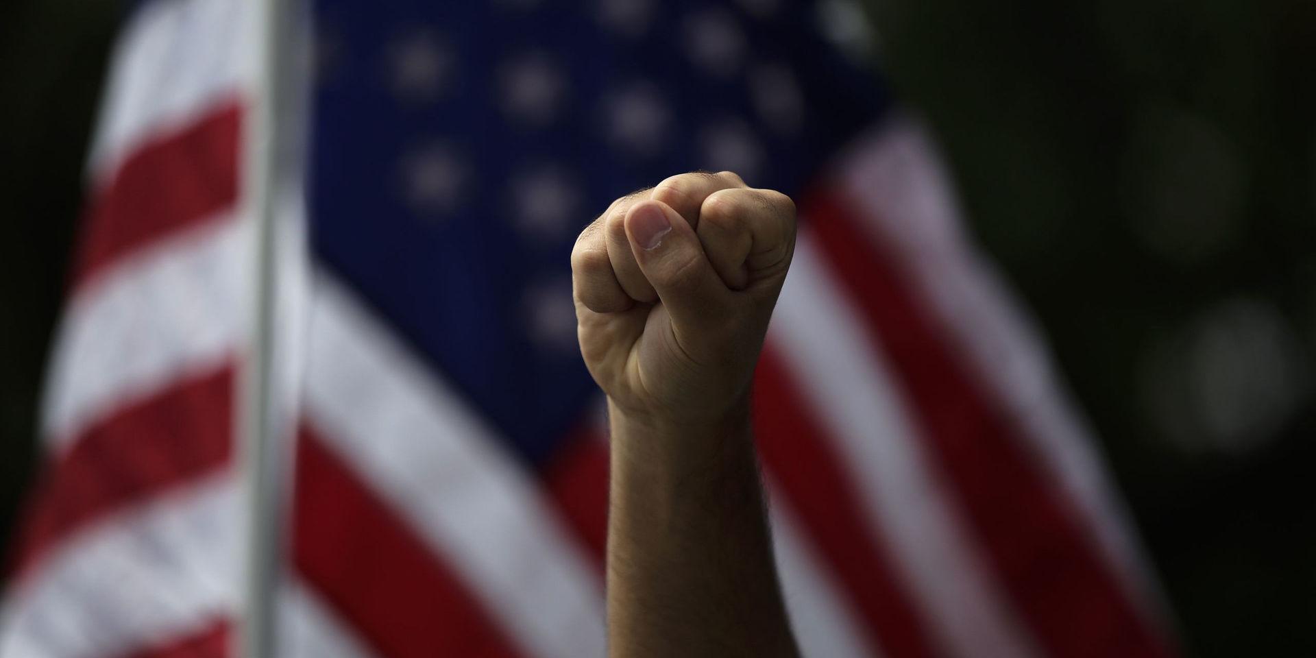 A demonstrator raises his fist during a protest Monday, June 1, 2020, over the death of George Floyd, in Anaheim, Calif. (AP Photo/Jae C. Hong)  CAJH103