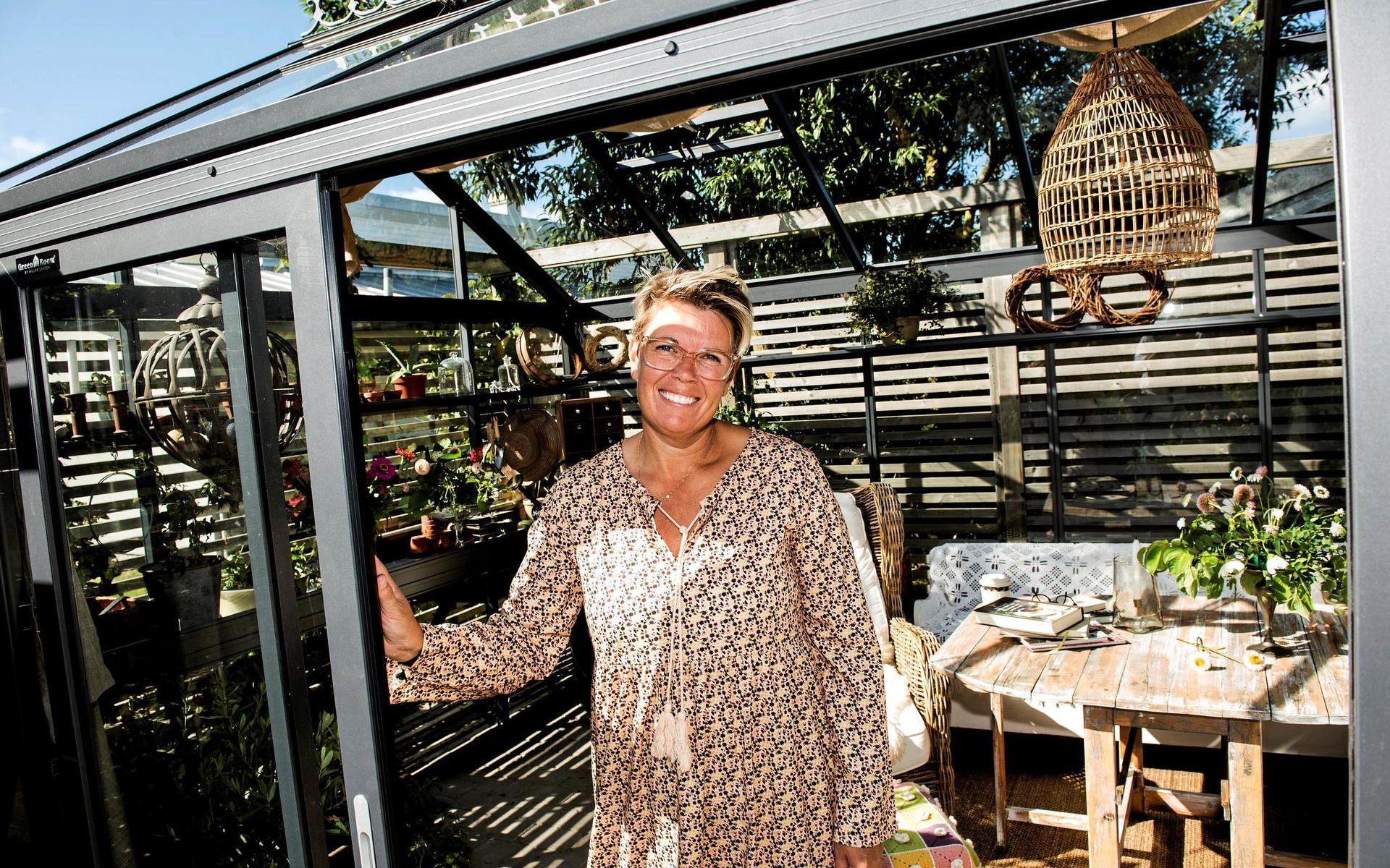Gunilla Wennerberg framför sitt växthus – som hon faktiskt vunnit i en tävling. ”Vi använder det både för odling och som ett mysigt uterum att sitta i.”