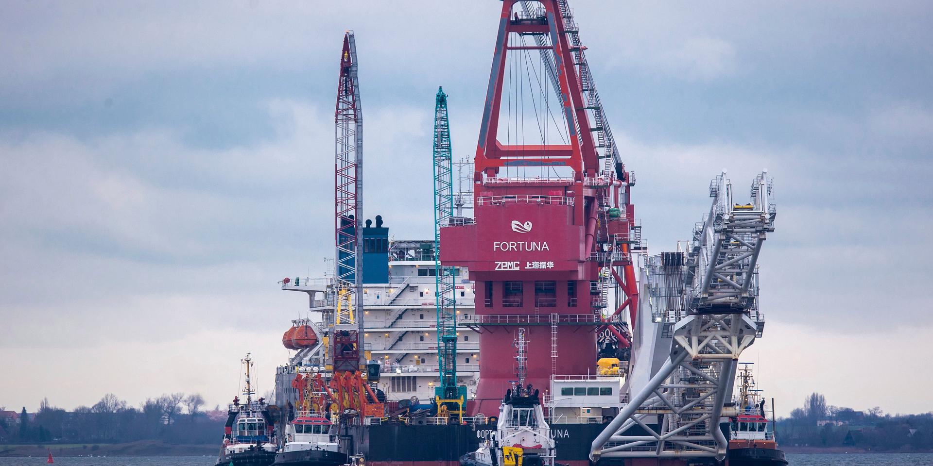 Tugboats get into position on the Russian pipe-laying vessel &quot;Fortuna&quot; in the port of Wismar, Germany, Thursday, Jan 14, 2021. The special vessel is being used for construction work on the German-Russian Nord Stream 2 gas pipeline in the Baltic Sea. ( Jens Buettner/dpa via AP)  DMSC121