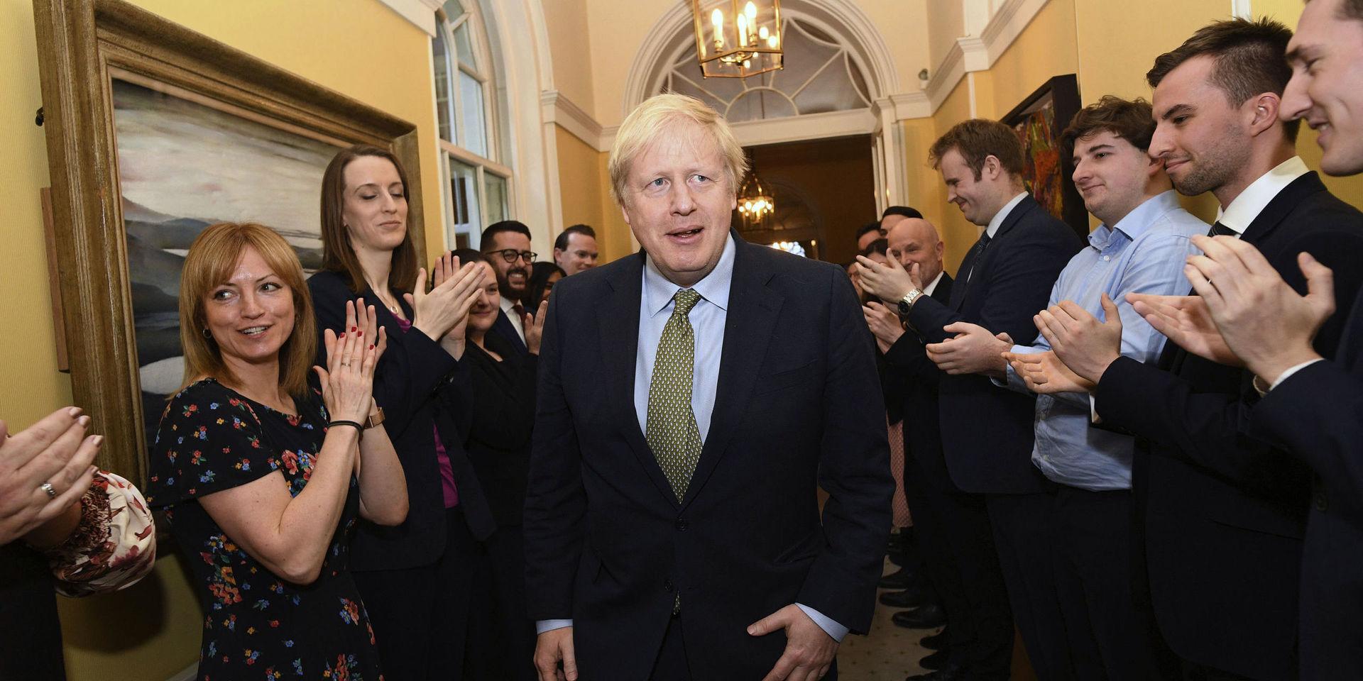 Britain&apos;s Prime Minister Boris Johnson is greeted by staff as he returns to 10 Downing Street, London, after meeting Queen Elizabeth II at Buckingham Palace and accepting her invitation to form a new government, Friday Dec. 13, 2019.  Boris Johnson led his Conservative Party to a landslide victory in Britain’s election that was dominated by Brexit. (Stefan Rousseau/PA via AP)  LBJ121